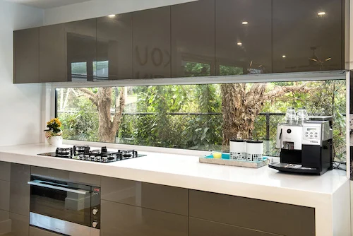 Medium wide shot of uPVC architectural windows in the Kitchen overlooking trees outside